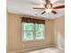 Bedroom boasts carpet flooring, neutral walls, one window, and a ceiling fan at 4810 Lismoor Trce, Mableton, GA 30126