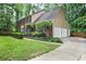 A traditional home featuring a two-car garage and lush greenery at 4810 Lismoor Trce, Mableton, GA 30126