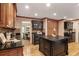 Spacious kitchen boasts dark cabinetry, granite countertops, hardwood flooring, and a central island at 4810 Lismoor Trce, Mableton, GA 30126