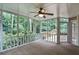 Relaxing screened porch with a ceiling fan and views of the lush, green backyard at 4810 Lismoor Trce, Mableton, GA 30126