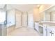 Bright bathroom featuring double vanities, granite countertops, a tub, and a glass-enclosed shower at 5381 Front Runner Ct, Sugar Hill, GA 30518