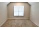 Bedroom featuring neutral carpeting and bright natural light from a central window at 5381 Front Runner Ct, Sugar Hill, GA 30518