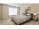 Cozy bedroom with a large window, neutral decor, and a comfortable-looking bed at 5381 Front Runner Ct, Sugar Hill, GA 30518