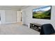 Spacious bedroom featuring gray carpet, neutral paint, TV, and a built-in media console at 5381 Front Runner Ct, Sugar Hill, GA 30518