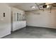 Bright garage with white shelving units, concrete flooring, and an automatic door at 5381 Front Runner Ct, Sugar Hill, GA 30518