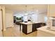 Beautiful kitchen featuring an island, hardwood flooring, and seamless access to the living room at 5381 Front Runner Ct, Sugar Hill, GA 30518