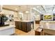 Open kitchen with a large island, stainless appliances, and a view to the living room at 5381 Front Runner Ct, Sugar Hill, GA 30518