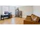 Comfortable living room with a brown leather couch and black metal bookshelves at 5381 Front Runner Ct, Sugar Hill, GA 30518