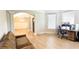 Cozy living room with hardwood floors, light walls, and a view of the dining area at 5381 Front Runner Ct, Sugar Hill, GA 30518