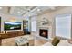 Inviting living room with a fireplace, built-in shelving and a coffered ceiling at 5381 Front Runner Ct, Sugar Hill, GA 30518