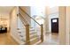 Elegant staircase leading to a grand foyer, showcasing the home's open layout and design at 5381 Front Runner Ct, Sugar Hill, GA 30518