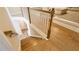 Beautiful staircase with hardwood steps and white railing leading to the lower level at 5381 Front Runner Ct, Sugar Hill, GA 30518