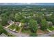 Scenic aerial view showcasing a neighborhood with tree-lined streets and well-maintained homes at 10865 Glenhurst Pass, Duluth, GA 30097