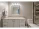 Bright bathroom with a white vanity, granite countertop, and tiled shower at 10865 Glenhurst Pass, Duluth, GA 30097