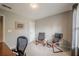 A well-lit bedroom featuring neutral walls, carpet and two comfortable accent chairs at 10865 Glenhurst Pass, Duluth, GA 30097