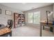 Bedroom with a large window, a cozy desk, and a bookshelf; perfect for studying or working at 10865 Glenhurst Pass, Duluth, GA 30097