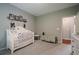Bedroom with white crib, carpet, and wall decorations at 10865 Glenhurst Pass, Duluth, GA 30097
