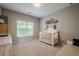 Bright Bedroom with a white crib, natural light, and neutral walls at 10865 Glenhurst Pass, Duluth, GA 30097