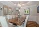 Elegant dining room featuring a large wood table, chair seating for ten, and a stylish light fixture at 10865 Glenhurst Pass, Duluth, GA 30097