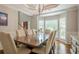 Spacious dining room featuring a large wood table, chair seating for ten, and a bay window at 10865 Glenhurst Pass, Duluth, GA 30097