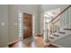 Inviting home entrance featuring hardwood floors, stylish door and staircase to the upper level at 10865 Glenhurst Pass, Duluth, GA 30097