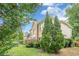 A well-maintained side view showcases meticulous landscaping and lush greenery at 10865 Glenhurst Pass, Duluth, GA 30097