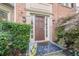 Inviting front entry with a wood door, decorative sidelights, and manicured shrubs at 10865 Glenhurst Pass, Duluth, GA 30097