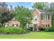 Traditional brick home boasting a manicured lawn and mature landscaping at 10865 Glenhurst Pass, Duluth, GA 30097