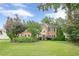 Traditional brick home boasting a manicured lawn and mature landscaping at 10865 Glenhurst Pass, Duluth, GA 30097