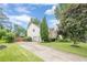 Side view featuring well-maintained landscaping and a two-car garage at 10865 Glenhurst Pass, Duluth, GA 30097