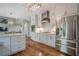 Modern kitchen featuring stainless steel appliances, white cabinets, and an open view to the living area at 10865 Glenhurst Pass, Duluth, GA 30097