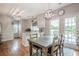 Cozy kitchen and dining area featuring white cabinets, modern lighting, and outdoor access at 10865 Glenhurst Pass, Duluth, GA 30097