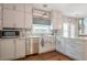 Bright eat-in kitchen featuring white cabinets, stainless appliances, and beautiful countertop space at 10865 Glenhurst Pass, Duluth, GA 30097