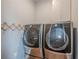 Laundry area featuring new front-load washer and dryer with storage at 10865 Glenhurst Pass, Duluth, GA 30097