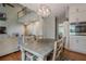 Open-concept living space featuring a dining area, kitchen, and a large staircase with balcony at 10865 Glenhurst Pass, Duluth, GA 30097