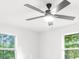 Bright bedroom featuring a ceiling fan and large windows offering a view of the outdoors at 30 Roseberry Dr, Stockbridge, GA 30281