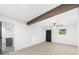 Spacious bedroom with wood floors, a decorative beam, and an attached bathroom at 30 Roseberry Dr, Stockbridge, GA 30281