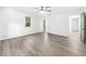 A bright bedroom includes modern ceiling fan, large window, and unique green door at 30 Roseberry Dr, Stockbridge, GA 30281