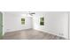 A light and bright bedroom features two windows with tree views and painted door at 30 Roseberry Dr, Stockbridge, GA 30281