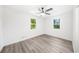 Bright, open bedroom with wood-style floors and large windows at 30 Roseberry Dr, Stockbridge, GA 30281