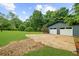Exterior view of home with a two-car garage, driveway, and expansive grassy area with trees at 30 Roseberry Dr, Stockbridge, GA 30281