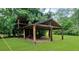 Backyard shed in a yard with an open-air design, showcasing the outdoor storage and lawn at 30 Roseberry Dr, Stockbridge, GA 30281
