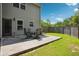 Backyard patio with outdoor seating and privacy fence, perfect for outdoor entertaining at 3796 Village Crossing Ln, Ellenwood, GA 30294