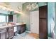Bathroom features a double vanity, dark cabinets, and updated lighting at 3796 Village Crossing Ln, Ellenwood, GA 30294