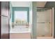 Soaking tub and shower combination in this bathroom at 3796 Village Crossing Ln, Ellenwood, GA 30294