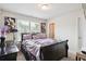 A comfortable bedroom with window and decorator wall art at 3796 Village Crossing Ln, Ellenwood, GA 30294