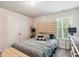 Cozy bedroom with tufted headboard, window view, and neutral decor, offering a relaxing space at 3796 Village Crossing Ln, Ellenwood, GA 30294