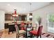 Cozy dining area featuring a round glass table and contemporary light fixture at 3796 Village Crossing Ln, Ellenwood, GA 30294