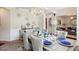 Elegant dining room with a chandelier, wainscoting, and ample seating for a formal dining experience at 3796 Village Crossing Ln, Ellenwood, GA 30294