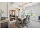 Bright dining room with a chandelier and large window, open to the living area, creating a spacious feel at 3796 Village Crossing Ln, Ellenwood, GA 30294